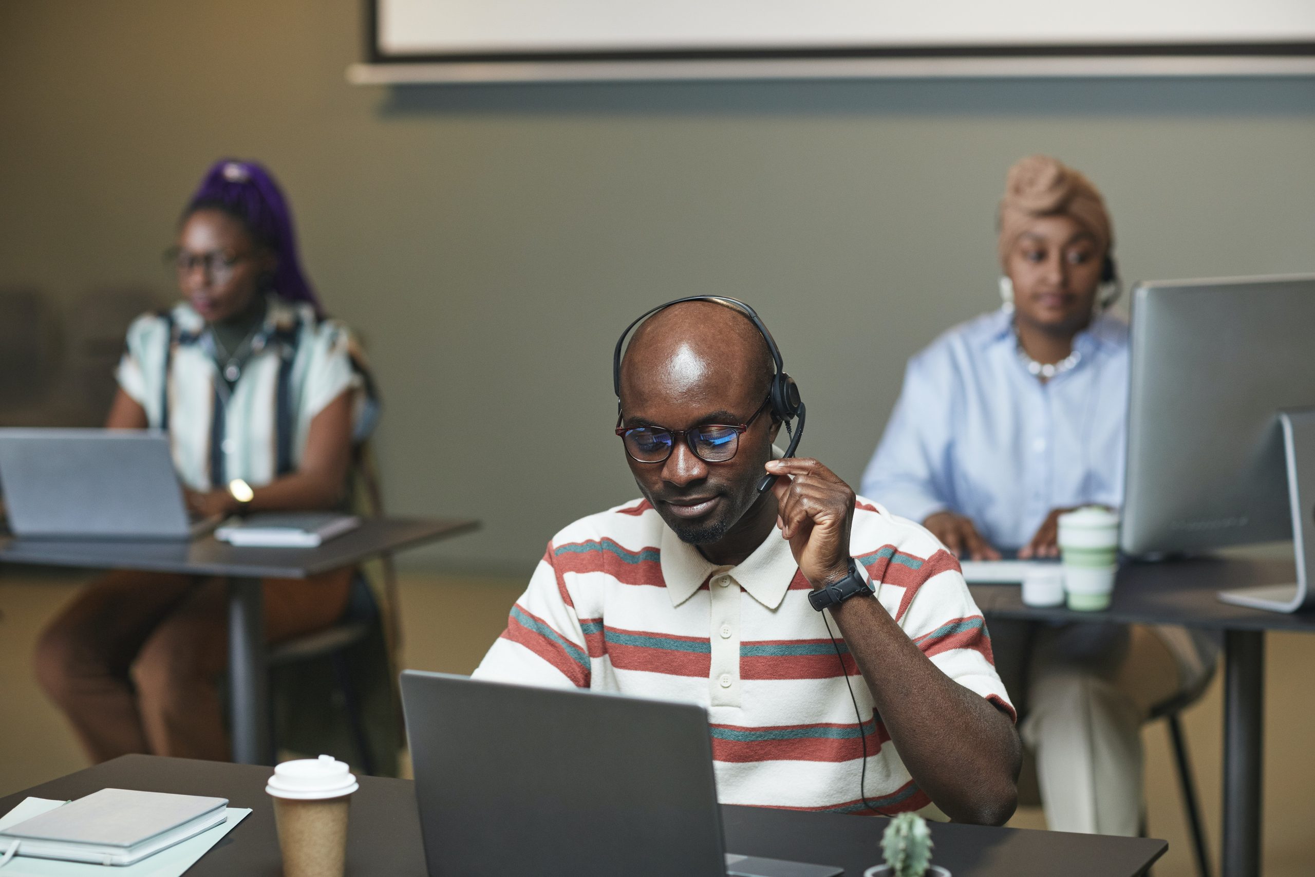 People working at laptops and computers