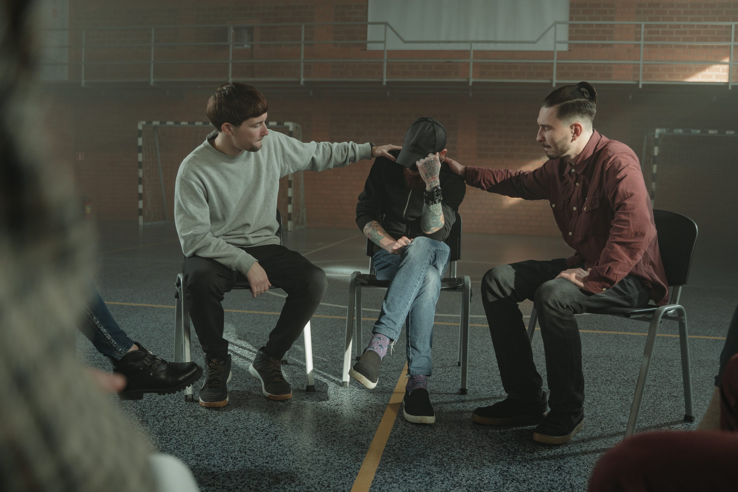 Three people seated in a support group setting